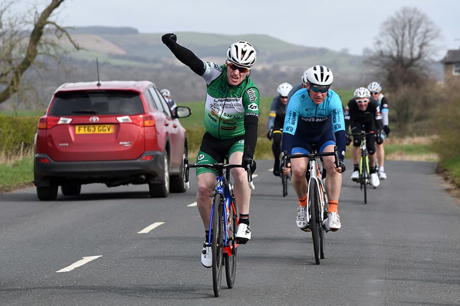 A racer celebrates on crossing the line first